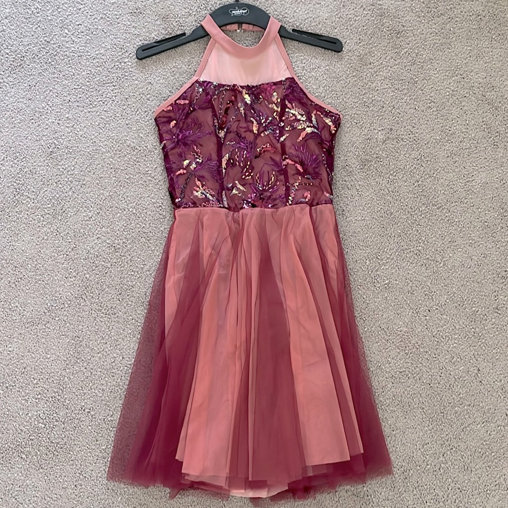 This is a large child costume from Revolution Dancewear. It is pink and burgundy